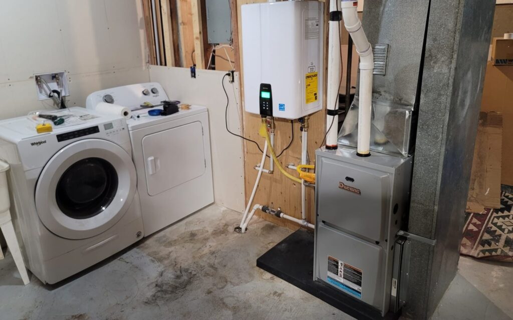 water heater repair in laundry room with washer dryer | GPS: 49.102023, -122.583738