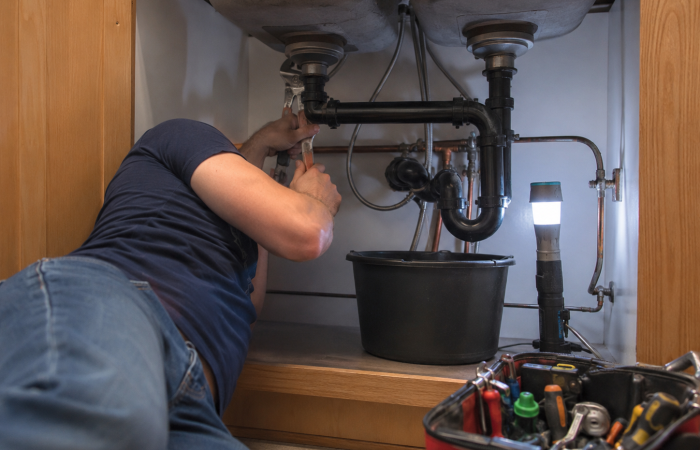 plumber-working-below-sink-langley-bathroom-renovation
